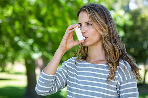 woman using an inhaler