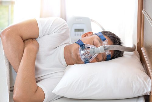 Man using CPAP Machine for sleep apnea