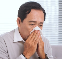 Man blowing his nose