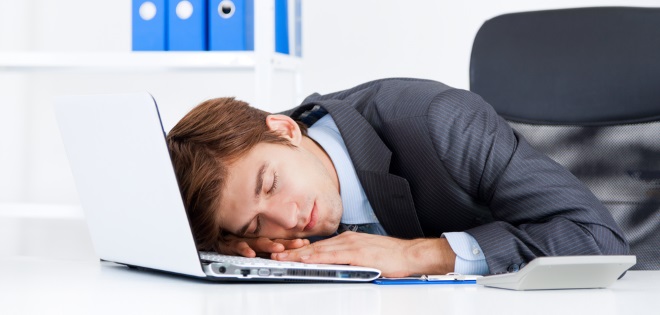 Man in an office suffering from Narcolepsy