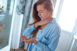 woman holding her neck