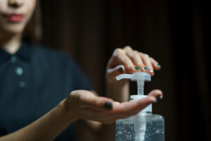 woman using hand sanitizer 