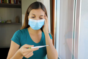 woman taking her temperature 