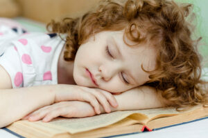 Child sleeping on a book