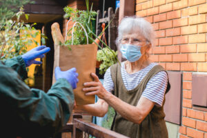 woman wearing mask while getting groceries 