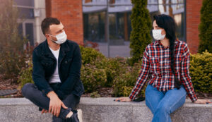 man and woman sitting on bench 