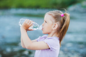 Young girl drinking water