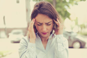 Young woman suffering from vertigo