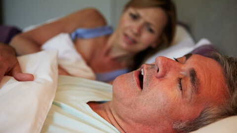 Woman annoyed by partner's snoring
