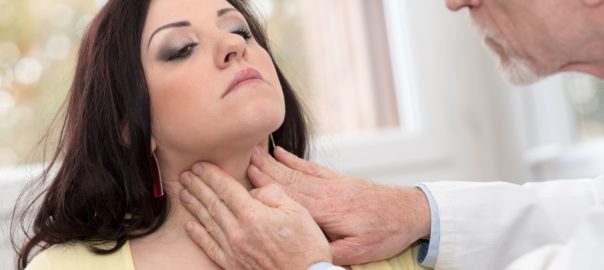 Doctor checking thyroid of a young patient